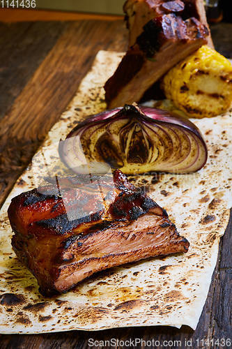 Image of Roasted sliced barbecue pork ribs, focus on sliced meat