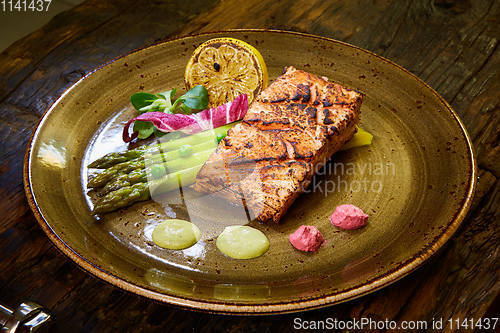 Image of Slow Cooked Salmon fillet steak with salad on plate, Sous-Vide Cooking Salmon Fish