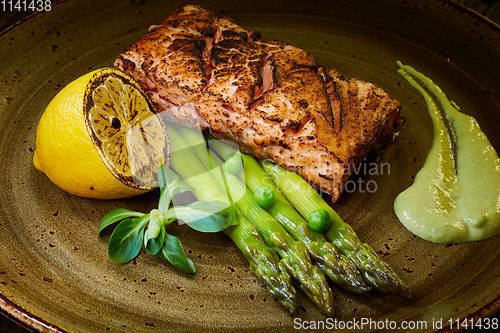 Image of Slow Cooked Salmon fillet steak with salad on plate, Sous-Vide Cooking Salmon Fish