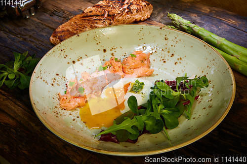 Image of Slow Cooked Salmon fillet steak with salad on plate, Sous-Vide Cooking Salmon Fish