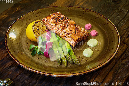 Image of Slow Cooked Salmon fillet steak with salad on plate, Sous-Vide Cooking Salmon Fish