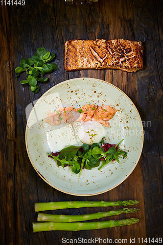 Image of Slow Cooked Salmon fillet steak with salad on plate, Sous-Vide Cooking Salmon Fish