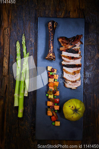 Image of Roasted sliced barbecue pork ribs, focus on sliced meat