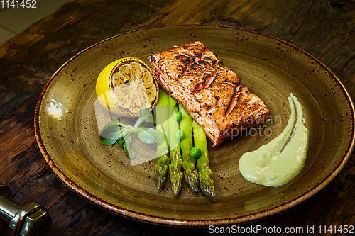 Image of Slow Cooked Salmon fillet steak with salad on plate, Sous-Vide Cooking Salmon Fish