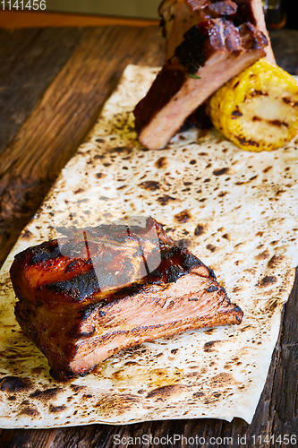 Image of Roasted sliced barbecue pork ribs, focus on sliced meat