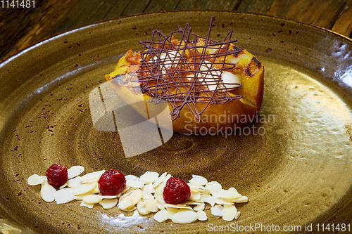 Image of Grilled pear dessert decorated with chocolate and almonds