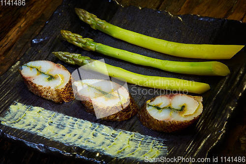 Image of The fish fillet with green asparagus. Shallow dof.