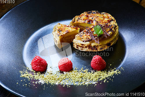 Image of Slice of vanilla cheesecake decorated with apple topping