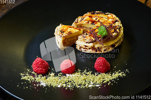 Image of Slice of vanilla cheesecake decorated with apple topping