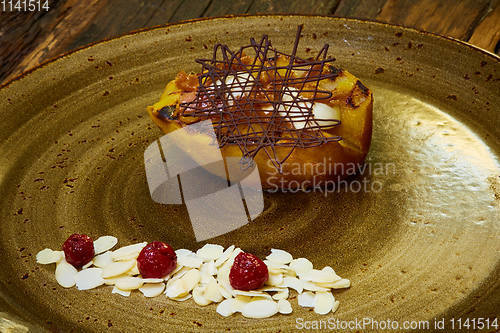 Image of Grilled pear dessert decorated with chocolate and almonds