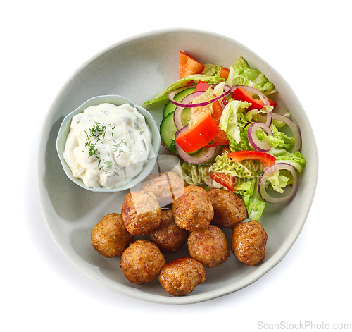 Image of plate of meat balls and vegetable salad