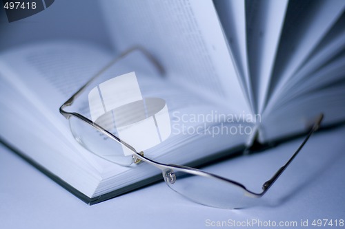 Image of opened book and glasses