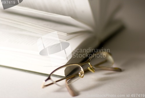 Image of opened book and glasses