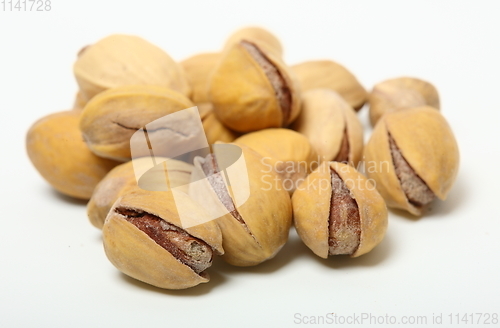 Image of Heap of organic salted pistachio nuts on white background