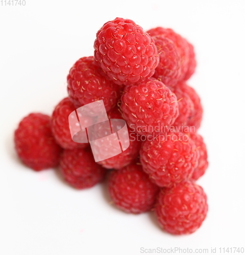 Image of The pyramid of ripe raspberry over white background