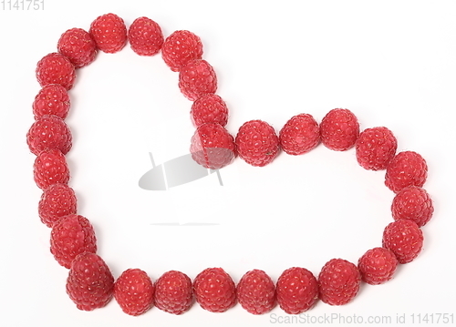 Image of Heart made out of raspberries over white background