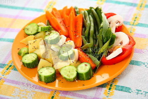Image of Salad with cucumbers, boiled potato, asparagus, spices, carrots 