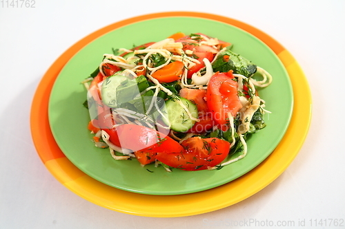 Image of The salad with cucumbers, tomatoes and herbs