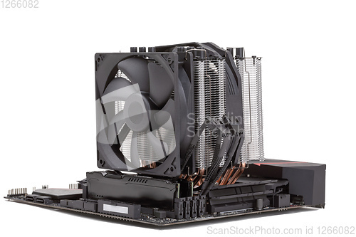 Image of PC mainboard with CPU cooler on white
