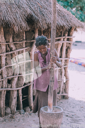 Image of woman crushing the millet, Africa, Namibia