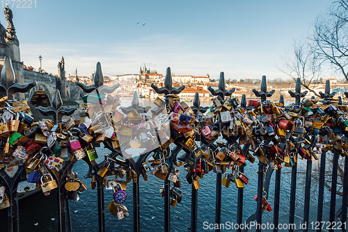 Image of Lots of love locks attached to railings near to Charles Bridge