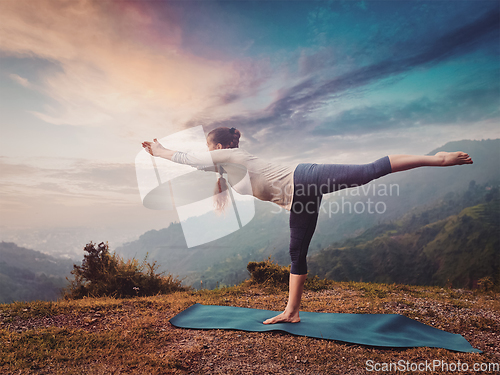 Image of Woman doing Ashtanga Vinyasa Yoga asana Virabhadrasana 3 Warrior