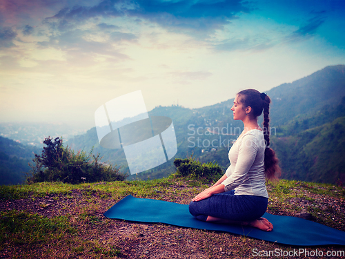 Image of Woman doing Yoga asana Virasana Hero pose