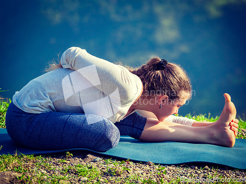 Image of Woman doing yoga asana outdoors
