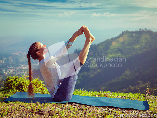 Image of Woman doing Ashtanga Vinyasa Yoga asana outdoors