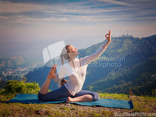 Image of Sorty fit woman doing yoga asana outdoors in mountains