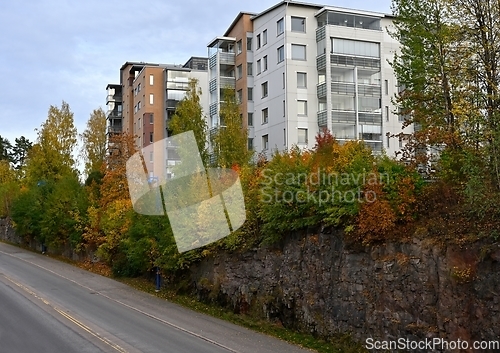 Image of residential area on a cliff and a road in autumn