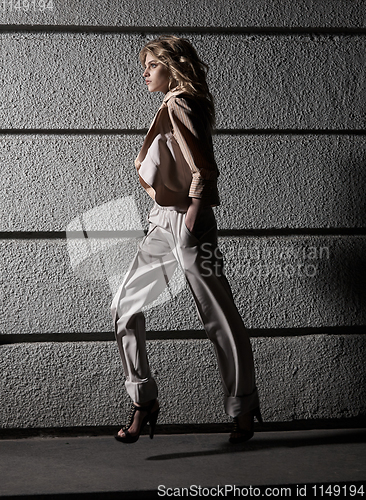 Image of Street fashion concept: full body portrait of young beautiful woman walking in the city. Model looking aside. Female fashion, beauty and advertisement concept. Close up. Copy space for text