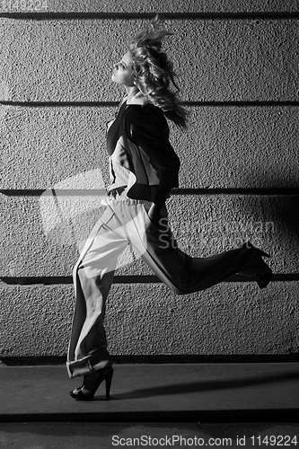 Image of Street fashion concept: full body portrait of young beautiful woman walking in the city. Model looking aside. Female fashion, beauty and advertisement concept. Close up. Copy space for text
