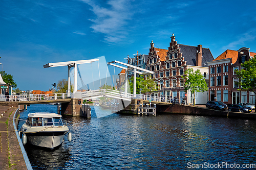 Image of Spaarne river with boat and Gravestenenbrug bridge in Haarlem, N