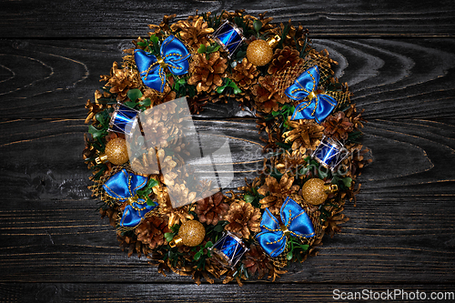 Image of Christmas wreath on wooden background