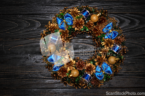 Image of Christmas wreath on wooden background
