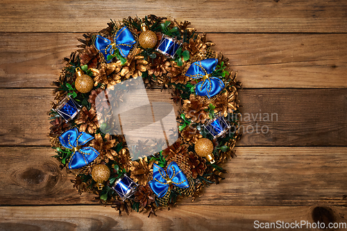 Image of Christmas wreath on wooden background