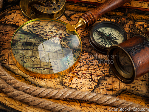 Image of Old vintage compass and navigation instruments on ancient map