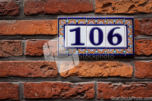 Image of Decorated house number on brick wall in Europe. Bruges (Brugge),