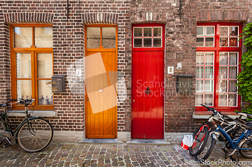 Image of Doors of old houses and bicycles in european city Bruges (Brugge