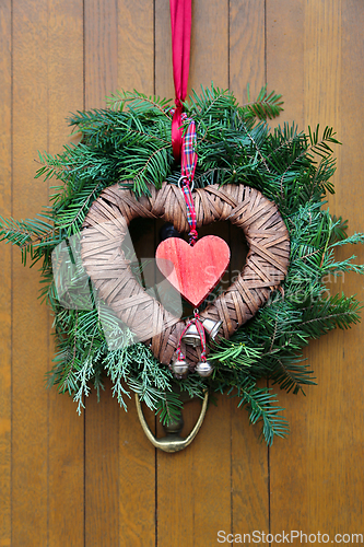 Image of Traditional christmas wreath on a wooden door