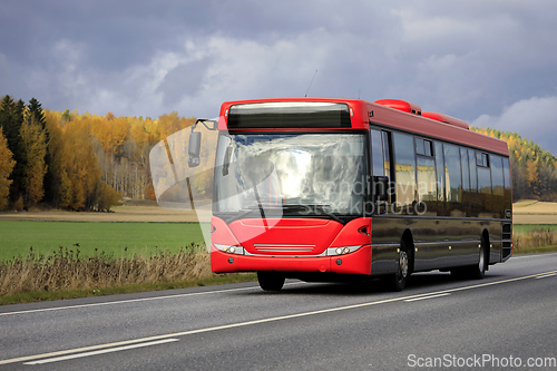 Image of Red Bus on Highway in Autumn