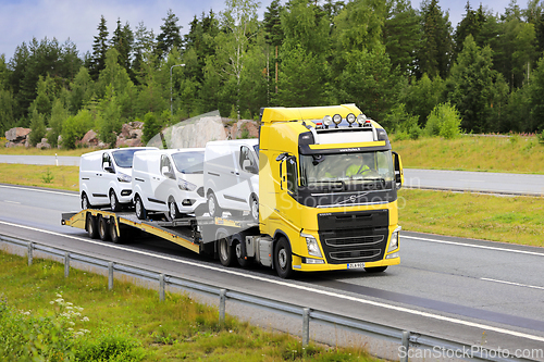 Image of Yellow Volvo FH Vehicle Carrier Transports New Ford Vans