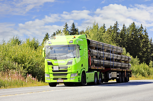 Image of Lime Green Scania R500 Truck Semi Trailer Hauls Metallic Pipes