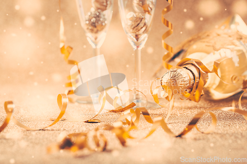 Image of Happy New Years Eve and Christmas celebration with 2 glasses , champagne and ornaments