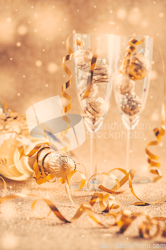Image of Happy New Years Eve and Christmas celebration with 2 glasses , champagne and ornaments