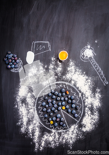 Image of Baking concept - ingredients for blueberry pie, sprinkled wheat flour circle