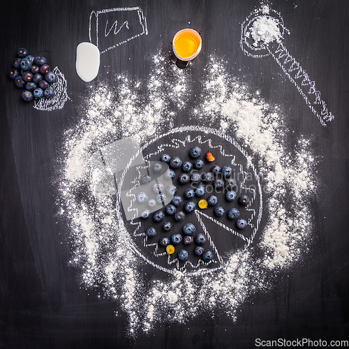 Image of Baking concept - ingredients for blueberry pie, sprinkled wheat flour circle