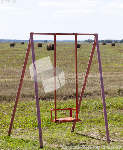 Image of old swing , field