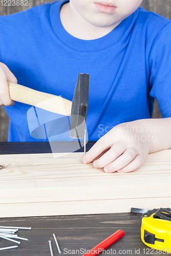 Image of a small boy is building